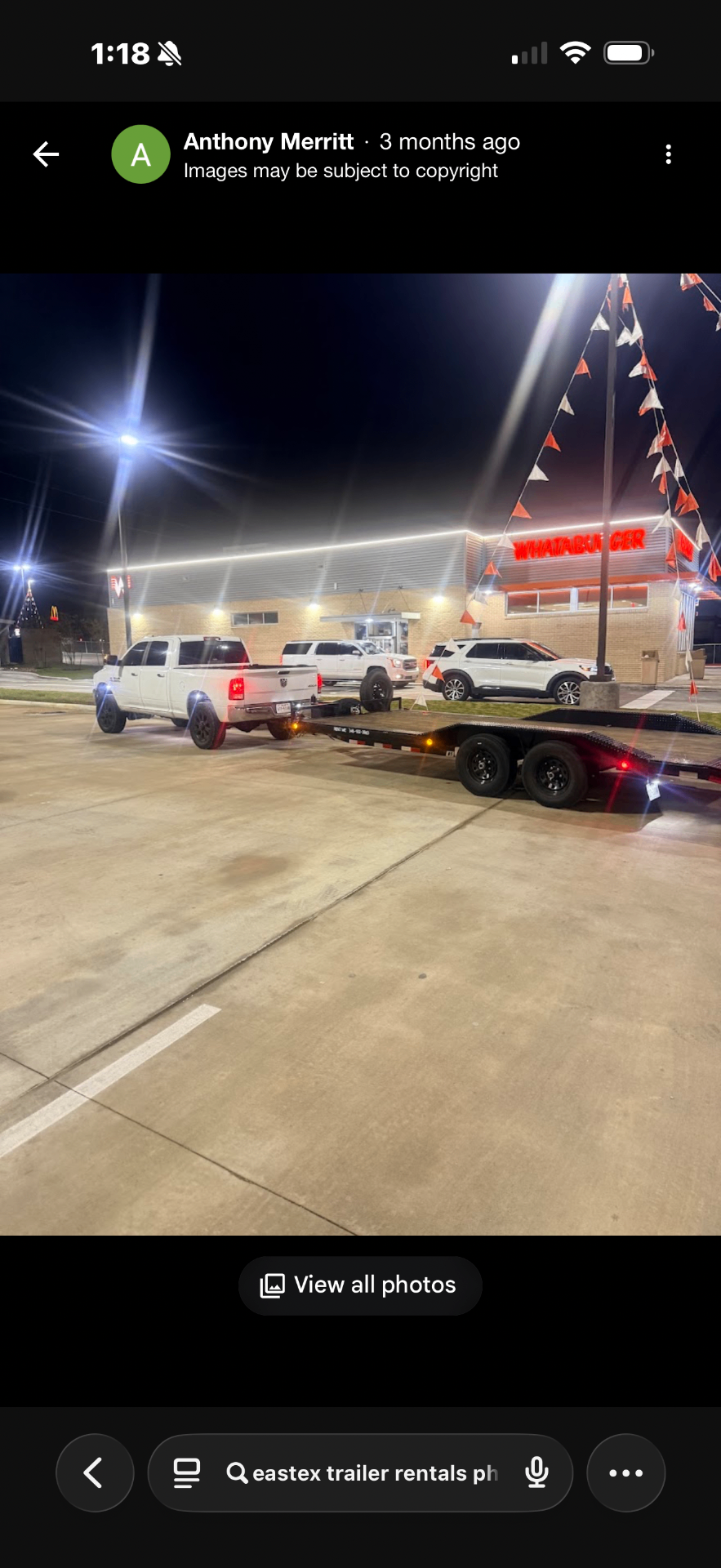 Ram 2500 with Eastex flatbed trailer at Whataburger at night