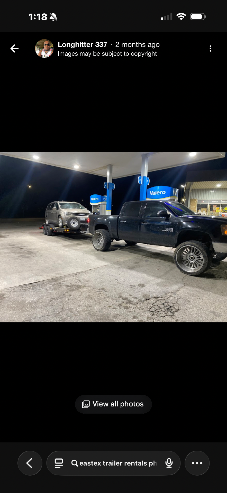 Lifted GMC Sierra towing minivan on Eastex trailer at Valero