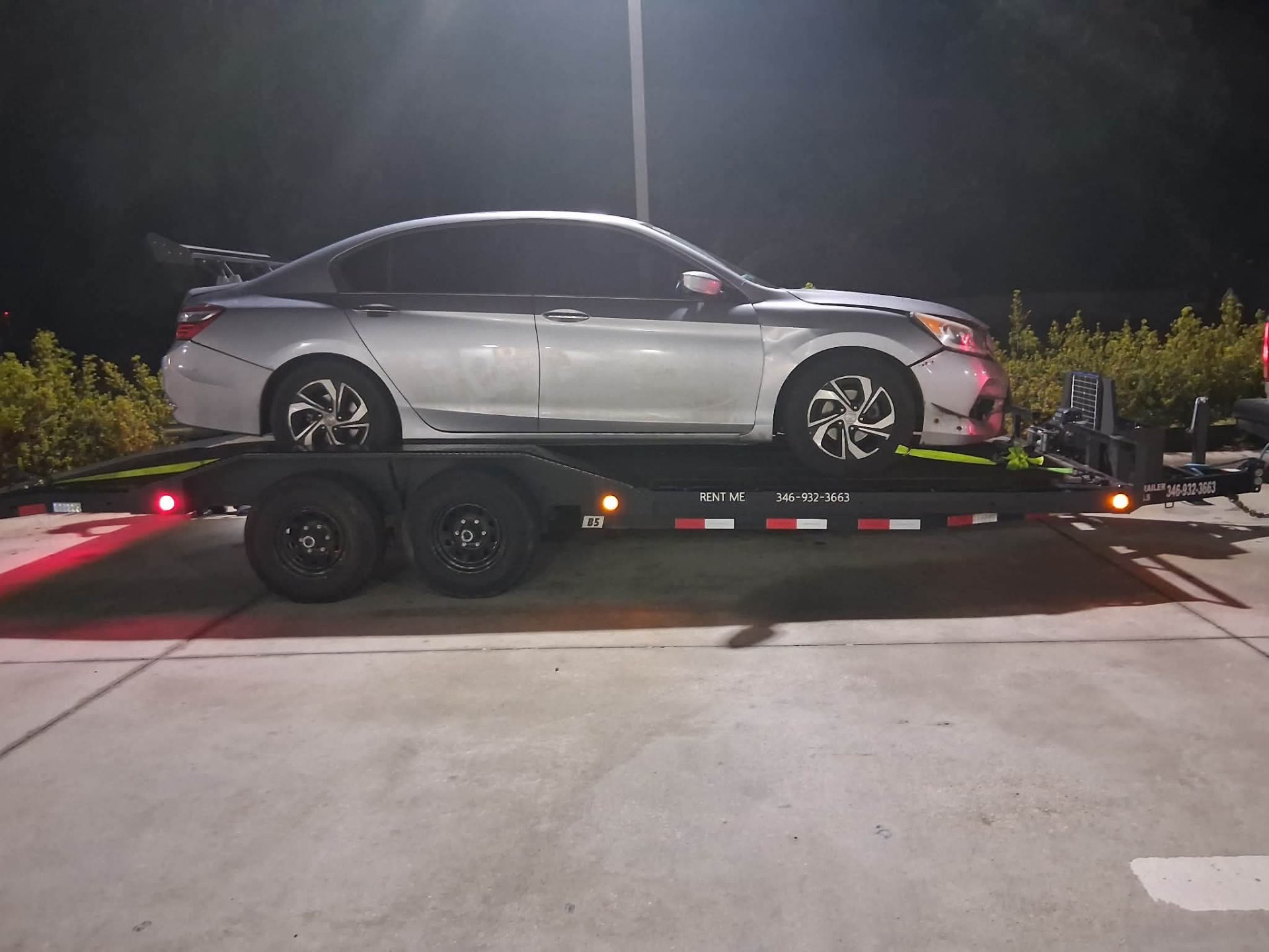 Silver Honda Accord loaded on Eastex car hauler at night